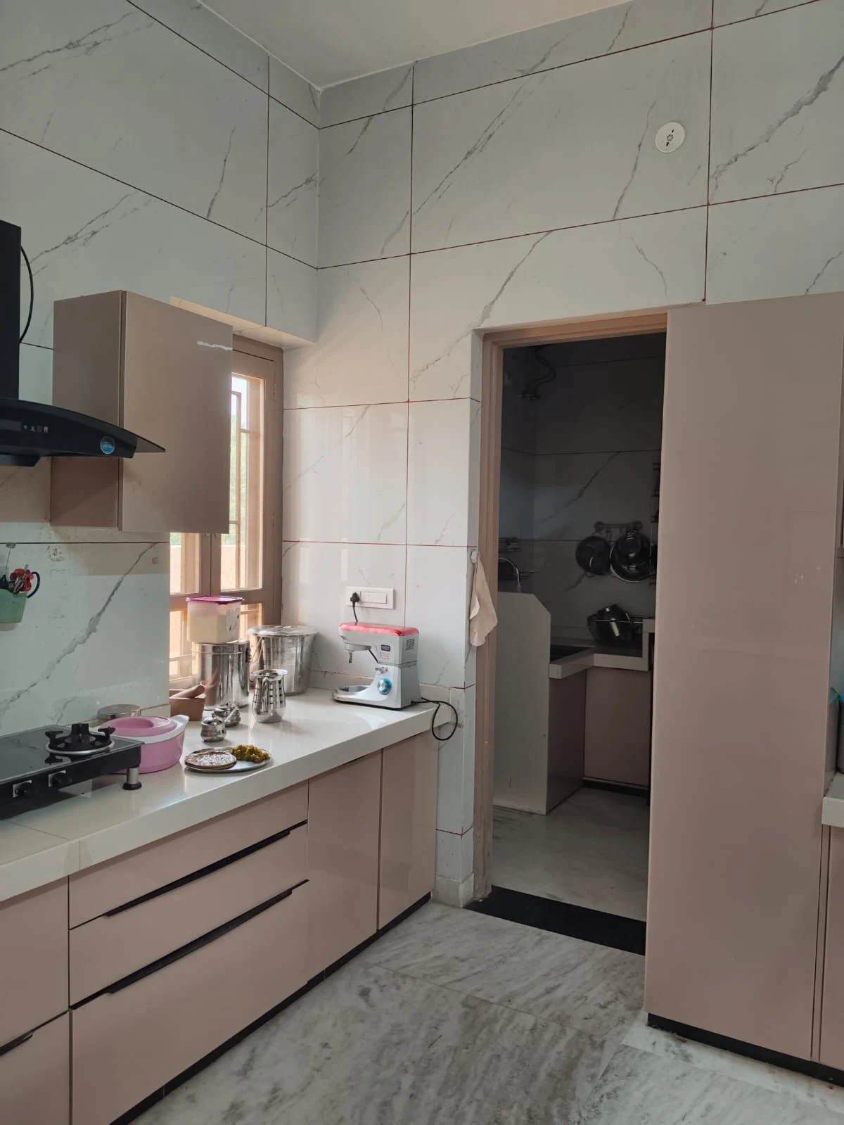 Ground-floor kitchen, from the entrance toward the countertop, cookware washing area and kitchen storage